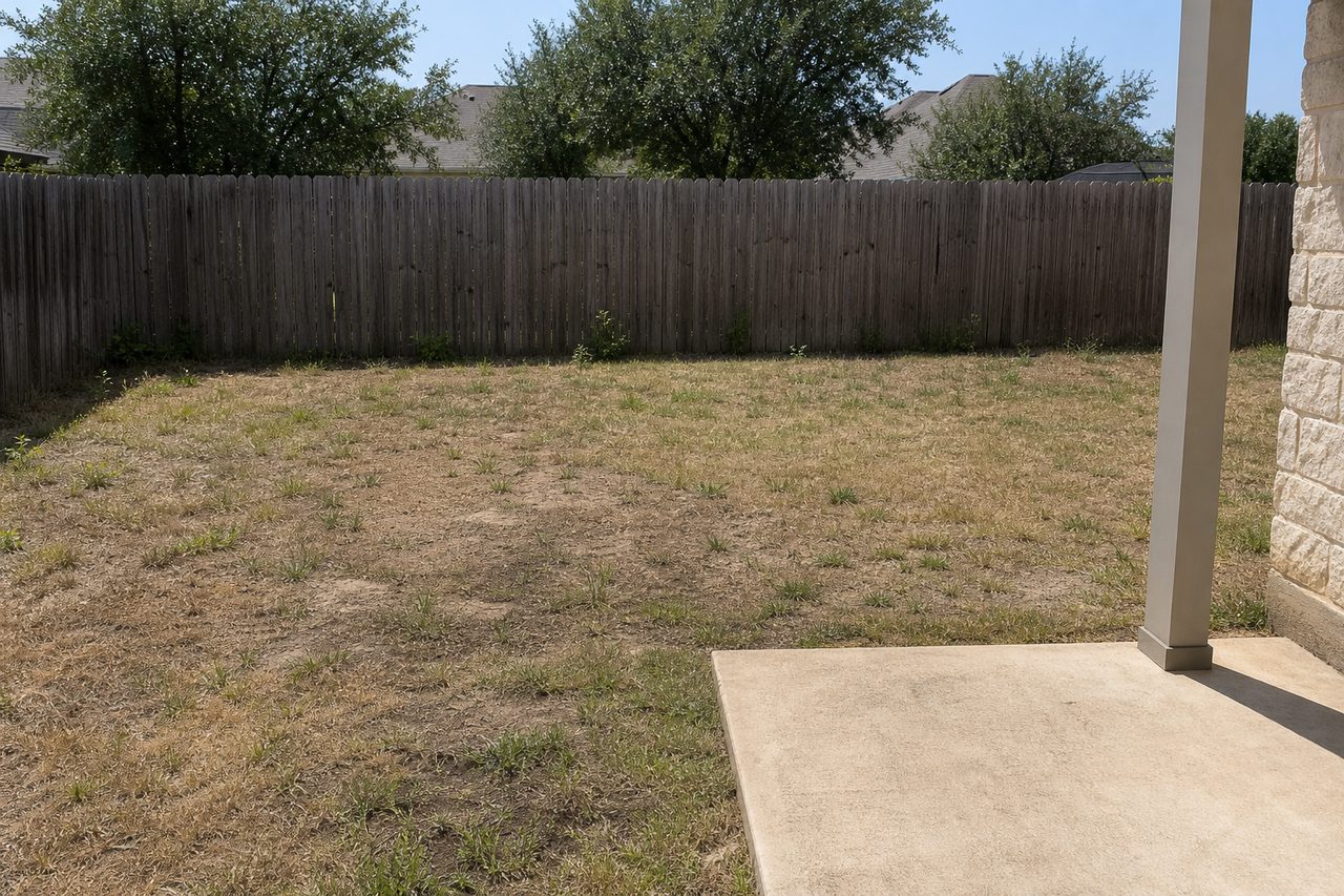 A patchy, neglected backyard before landscaping